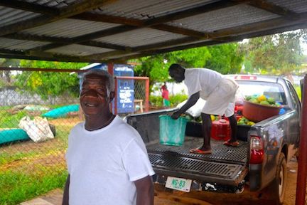 Joseph Thomas, with John Zeonyuway in the pick-up with food, two of the main staff in late April looking after the chimpanzees. (Photo: D. Stiles)